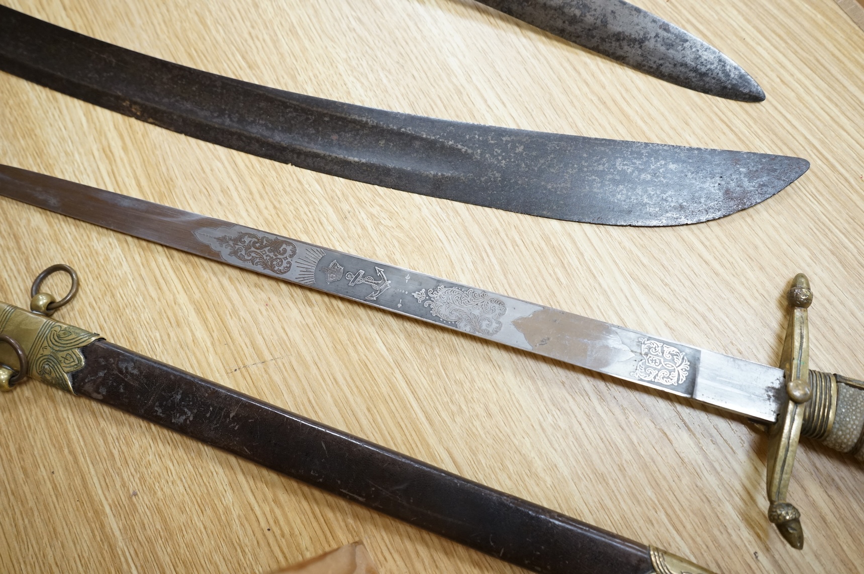 A post 1902 Naval Officer’s Dirk, the regulation blade with crowned fouled anchor, regulation hilt with remains of bullion dress knot in its leather scabbard with brass mounts, locket engraved with owners initials; RSA